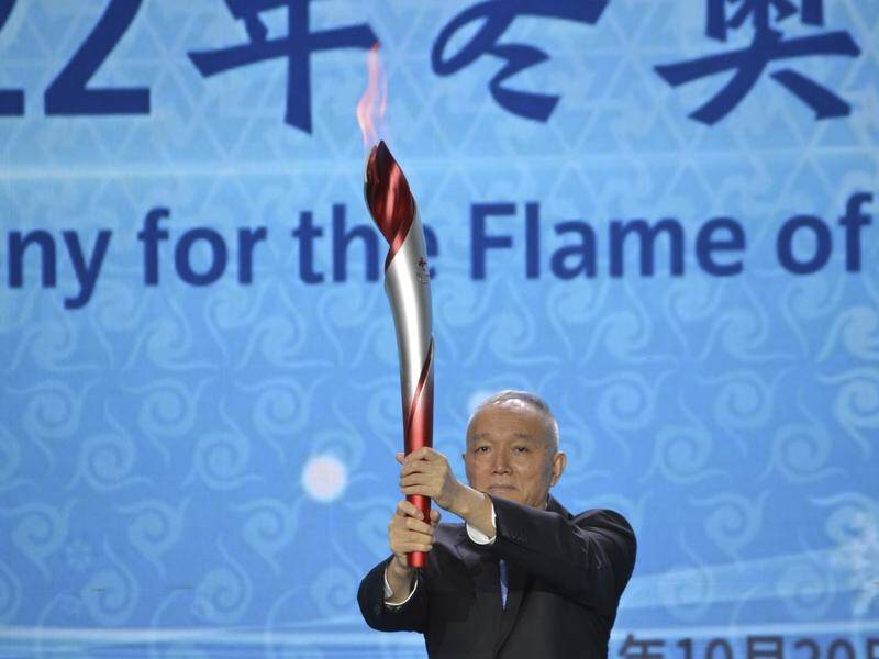 Cai Qi holds aloft the Olympic Flame that arrived in Beijing on Wednesday.