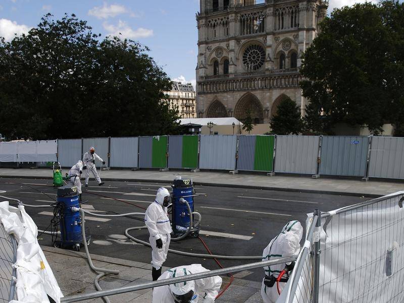 Restoration work has resumed at Notre Dame cathedral with measures to prevent lead contamination.