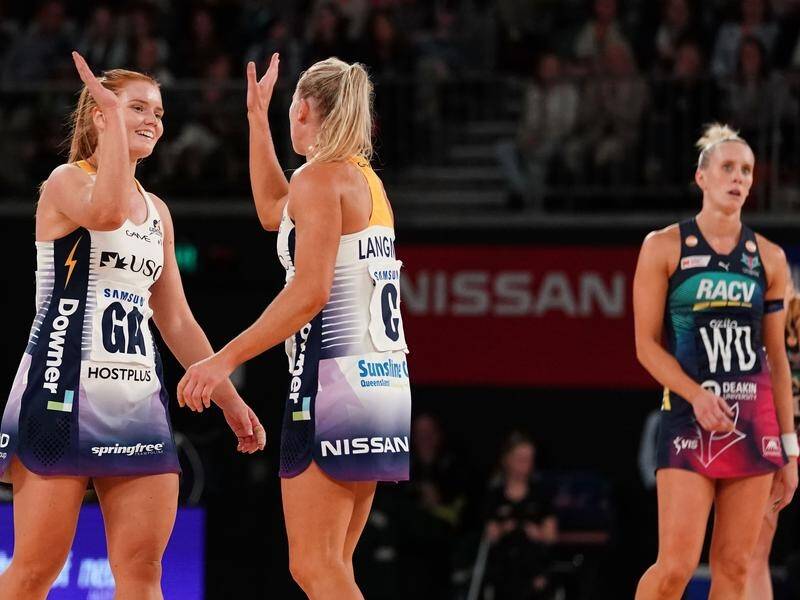 The Lightning's Stephanie Wood (L) celebrates taking her side top of the Super Netball ladder.