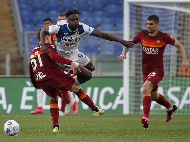 Roma's Riccardo Calafiori upends Atalanta's Duvan Zapata in their Serie A encounter.