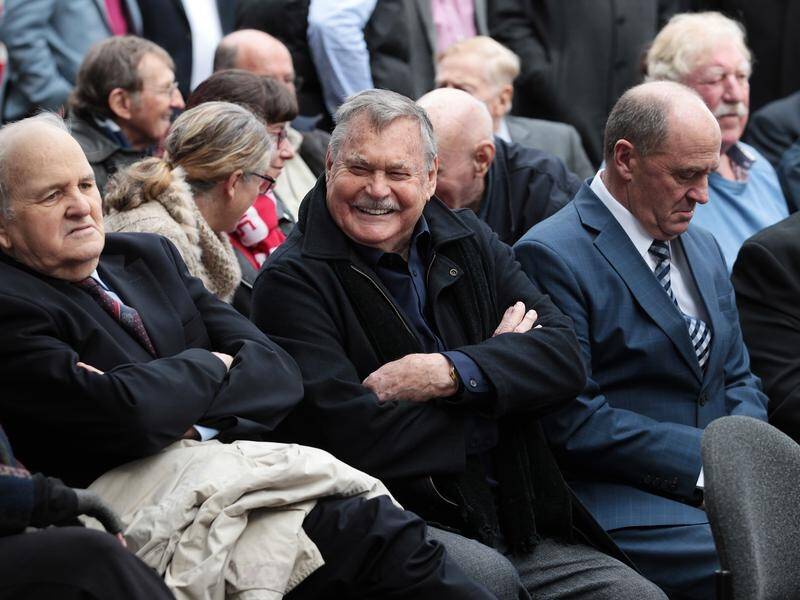 Ron Barassi (c) will miss Melbourne's premiership celebrations after testing positive to COVID-19.