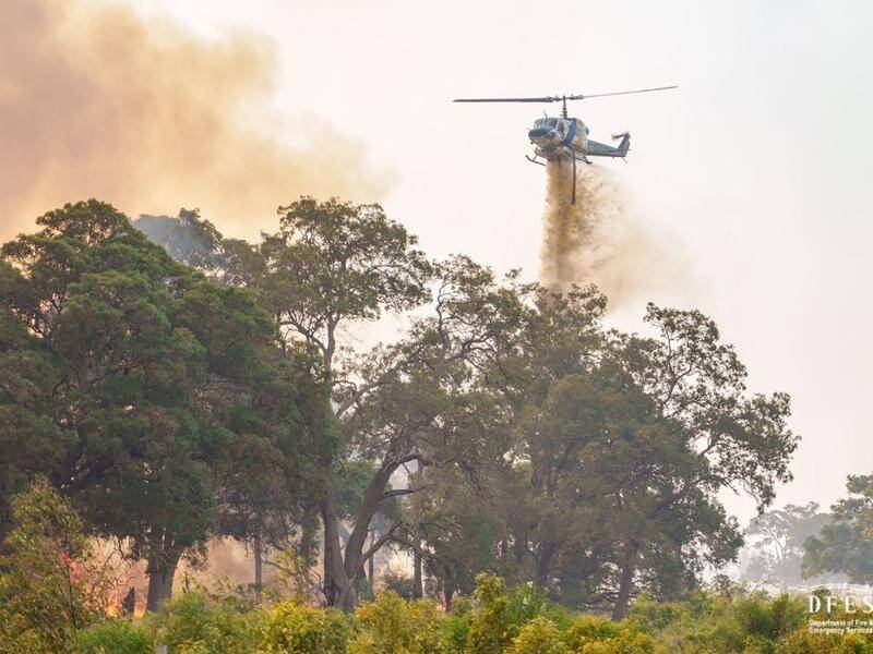 Helicopters have dropped sewerage wastewater on bushfires burning on homes in Perth's northeast (HANDOUT/DFES)