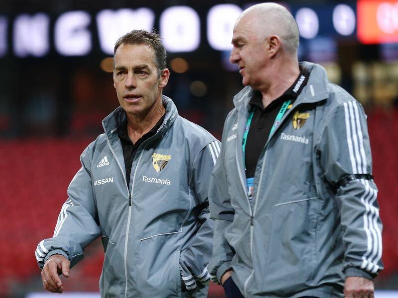 Alastair Clarkson (L) is concerned about Hawthorn's slow ball flow on their recent AFL matches.