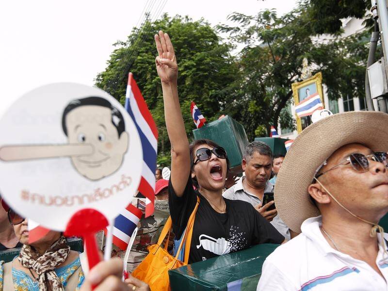 Protesters in Bangkok have carried signs depicting the Thai prime minister as Pinocchio.