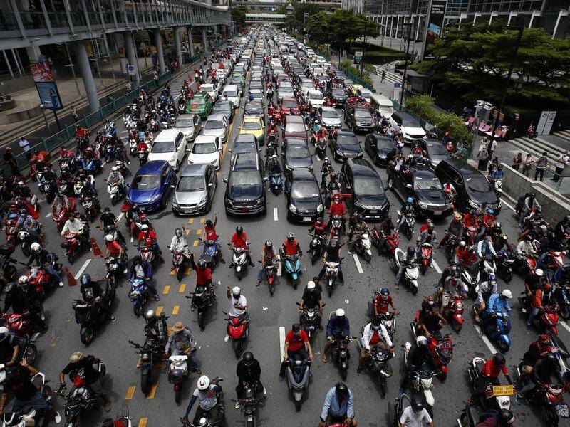 Drivers honked horns and motorcyclists raised three-finger salutes in central Bangkok.