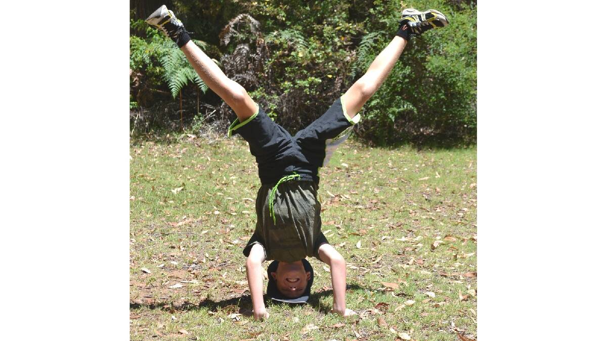 Headstand: Jaden Bateman enjoyed the great outdoors when he visited the Harris Dam as part of the PCYC school holiday program. Photo: Laura Newey/Collie Mail.