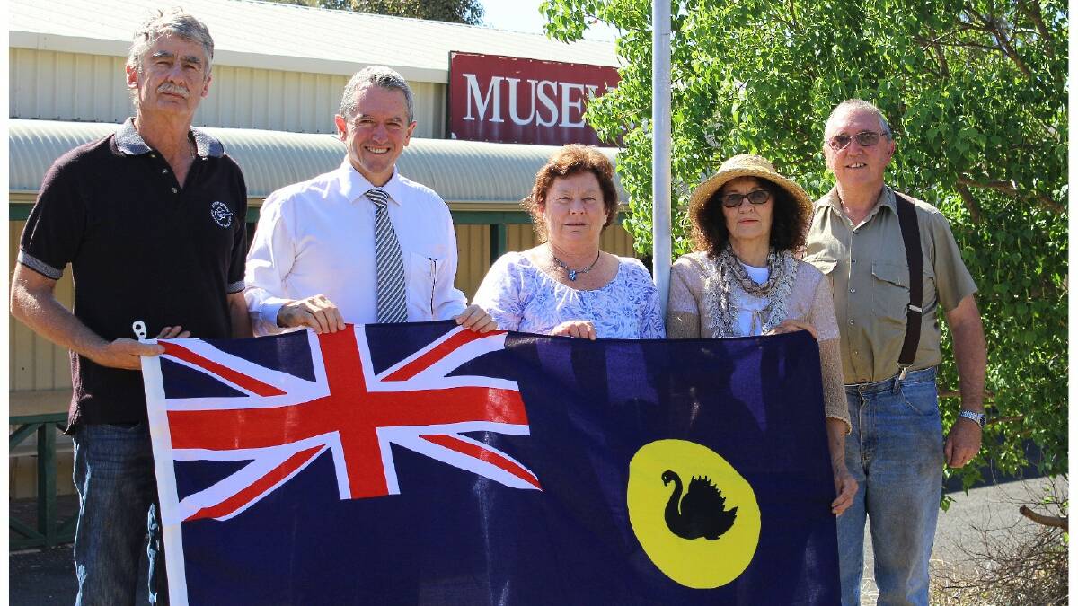Grant Wardle, Terry Redman, Jan Corker, Leila McCreery and John Walsh with a new flag for the Boyup Brook District Pioneers museum. Photo: Donnybrook-Bridgetown Mail.