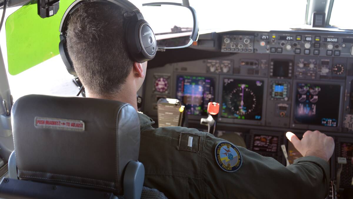 In this undated photo provided by the Navy Visual News Service, Lt. j.g. Kyle Atakturk, left, and Lt. j.g. Nicholas Horton, naval aviators assigned to Patrol Squadron (VP) 16, pilot a P-8A Poseidon during a mission to assist in search and rescue operations for Malaysia Airlines flight MH370. Pic: Getty Images