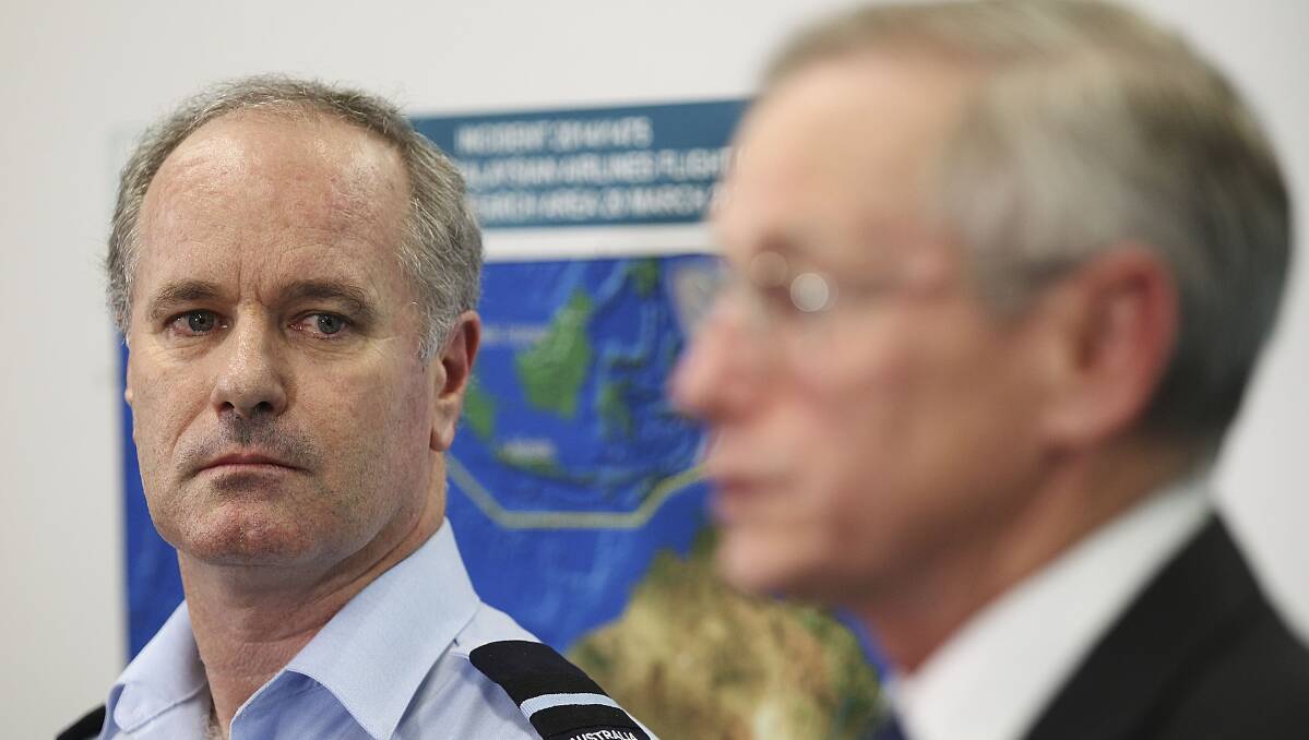 Australian Maritime Safety Authority Emergency Response Division general manager John Young, right, speaks to the media alongside Director General Military Strategic Commitments John McGarry about satellite imagery of objects possibly related to the search for Malaysian Airlines flight MH370 on March 20 in Canberra. Photo: Getty Images.