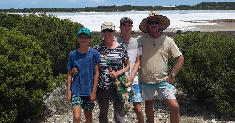 Stranded: Anita Donaldson (second left) with children Sully and Mack, and husband Brian (far right) in South Australia, where the Cowaramup family has been waiting for approval to return home to WA. Photos: Supplied