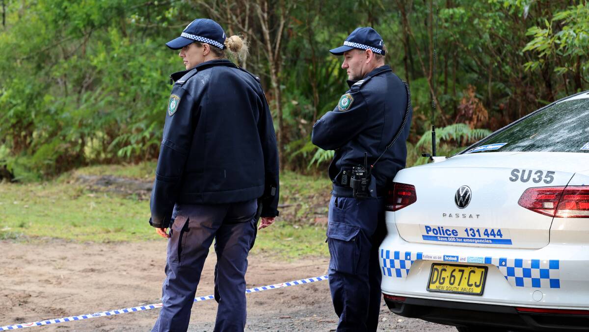 Police are combing bushland at Waterfall in the Royal National Park after skeletal remains of a person were found inside a burnt-out car early Tuesday morning. Pictures by Sylvia Liber