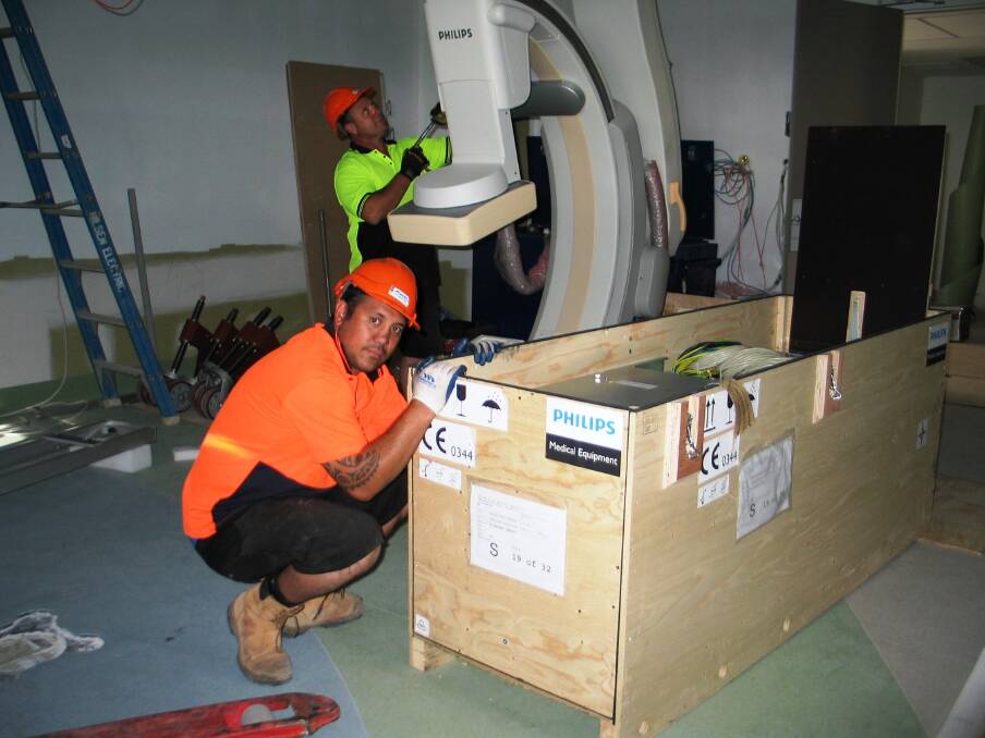 Raven Hoera and Paul Parkhill installing $1 million state-of-the-art angiography suite equipment at St John of God Bunbury Hospital. 